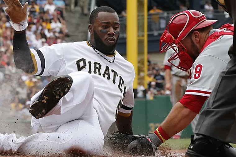 Josh Harrison scores ahead of the tag by Phillies catcher Cameron Rupp during the third inning in Pittsburgh on Sunday, July 6, 2014. (Gene J. Puskar/AP)
