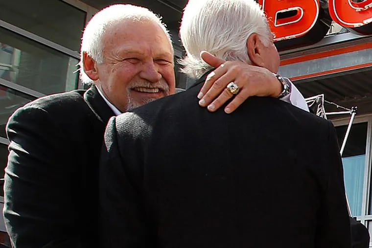 Bernie Parent (left) hugs Flyers chairman Ed Snider.