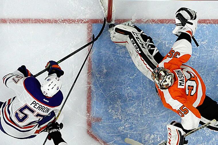 Flyers goalie Steve Mason blocks a shot by the Oilers' David Perron during the third period. (Matt Slocum/AP