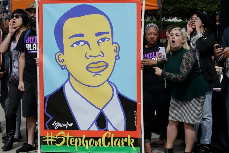 Protesters at an April 9 victims rights rally in Sacramento, Calif.,  display an image of Stephon Clark.