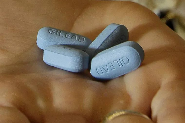 In this Thursday, May 10, 2012, file photo, a doctor holds Truvada pills at her office in San Francisco.
