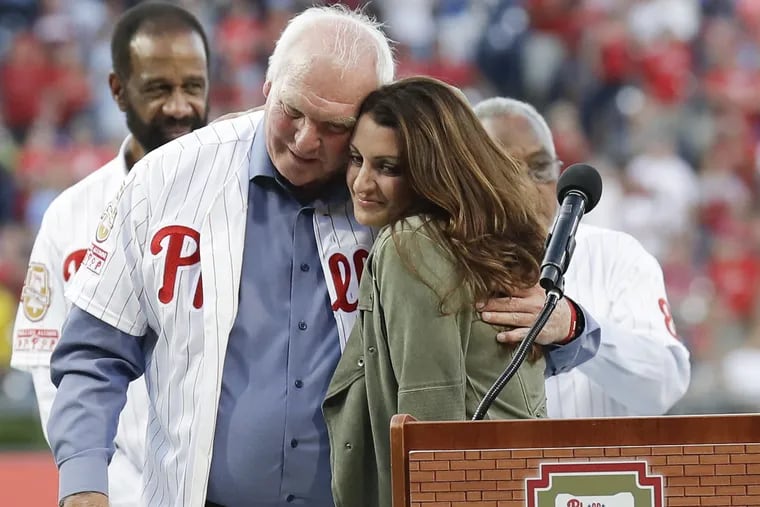 Wife of former Phillies pitcher Roy Halladay, Brandy Halladay, embraces former Phillies Manager Charlie Manuel during 2018 Wall of Fame ceremony before the Phillies play the Miami Marlins on Saturday, August 4, 2018 in Philadelphia. YONG KIM / Staff Photographer