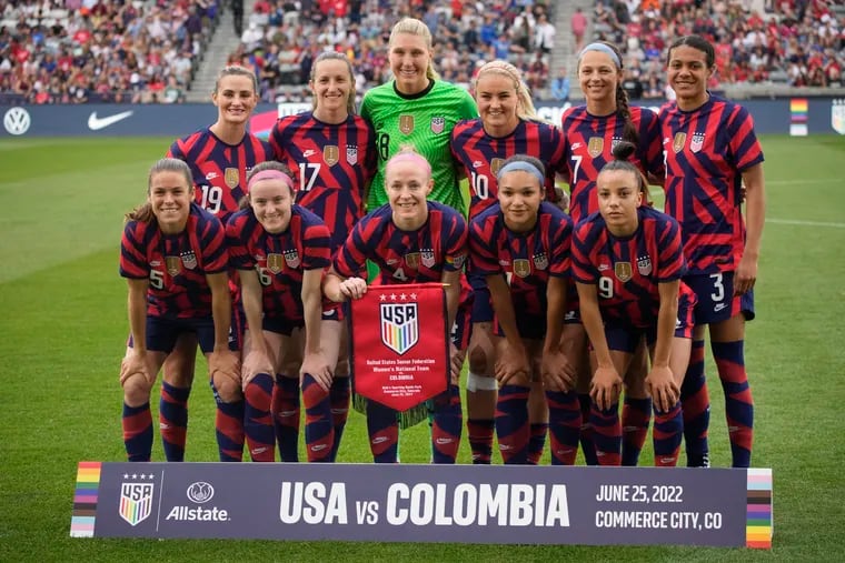U.S. women's soccer team captain Becky Sauerbrunn (front row, center) held up a rainbow-themed pennant to honor Pride Month at Saturday's game.