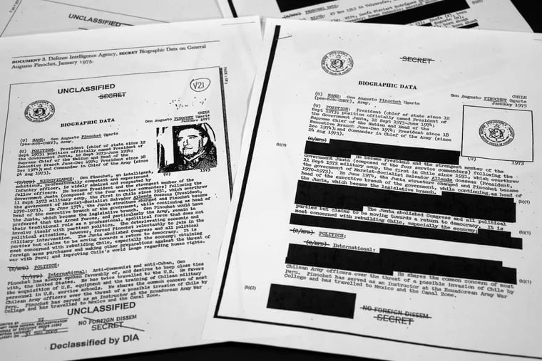 The redacted, right, and the unredacted versions of the biographical intelligence file report on Chilean dictator Augusto Pinochet from 1975 is photographed on April 15, 2019, in Washington. The redacted version of Robert Mueller's findings has been released.