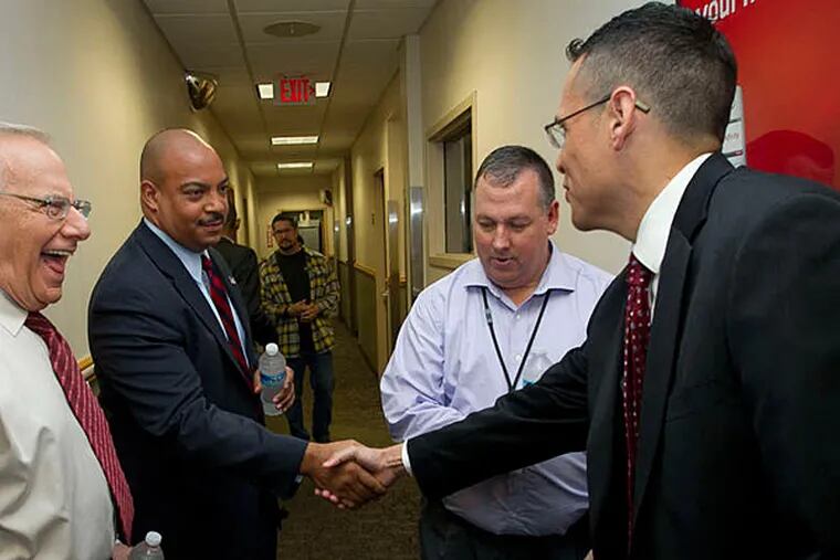 District Attorney Seth Williams (second from left) shakes hand with Danny Alvarez, his challenger in the Nov. 5 general election, yesterday after their debate. (Alejandro A. Alvarez/Staff)