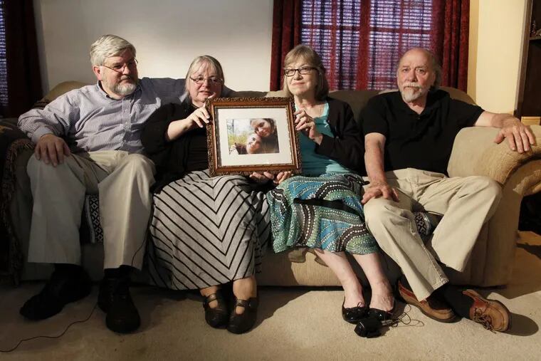 In this June 4, 2014, photo, from left, Patrick Boyle, Linda Boyle, Lyn Coleman and Jim Coleman hold photo of their kidnapped children, Joshua Boyle and Caitlan Coleman.