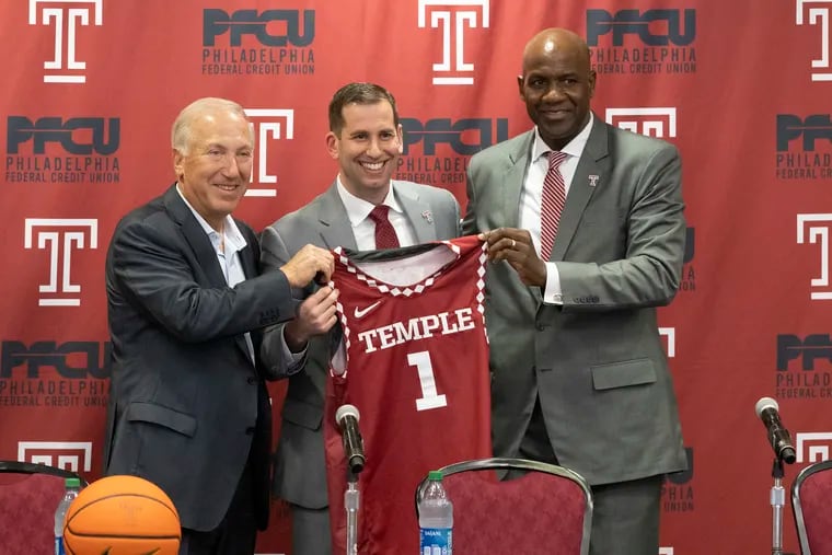 Temple University chairman Mitchell L. Morgan (left) and athletic director Arthur Johnson formally introduce new men's basketball coach Adam Fisher on April 5.
