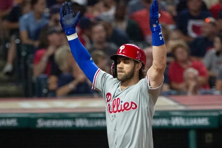 Bryce Harper makes an "O-H" gesture after his three-run homer in the fifth inning of the Phillies' 9-4 victory Saturday night in Cleveland. It was a nod to Ohio State, his wife's alma mater.