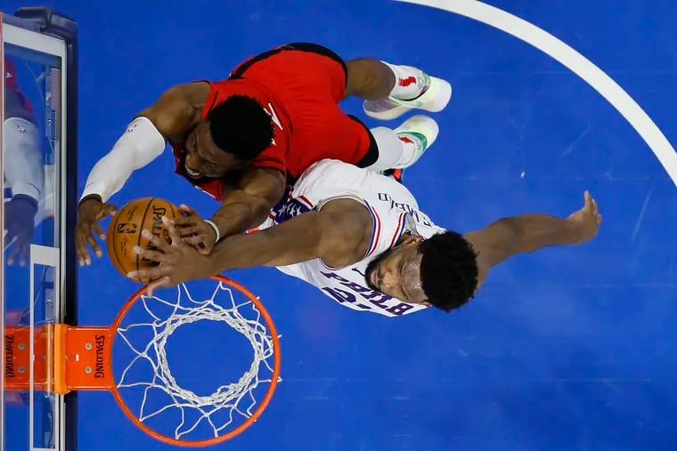 Joel Embiid, right, blocks a dunk by the Houston Rockets' David Nwaba during the second half.