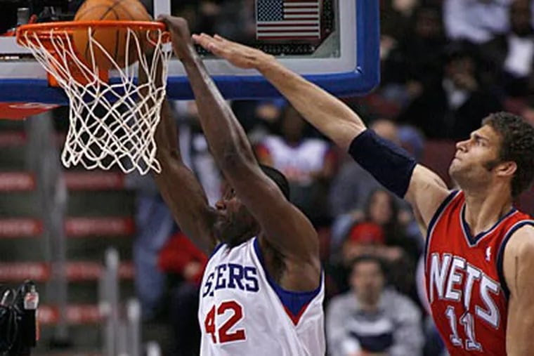 Nets center Brook Lopez is unable to block Elton Brand's dunk attempt. (H. Rumph Jr/AP Photo)