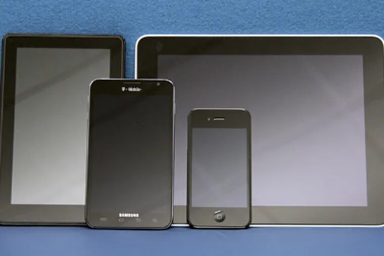 The Samsung Galaxy Note (second from left) with (from left) Kindle Fire, iPad, iPhone 4. (Elizabeth Robertson / Staff Photographer)