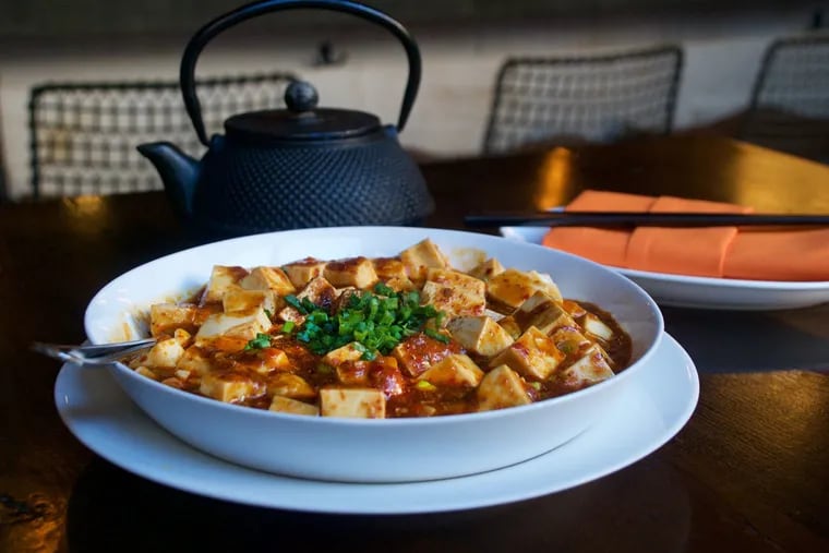 DanDan's vegan version of mapo tofu features silken tofu in a spicy broad bean sauce with Sichuan peppercorn powder and leeks.