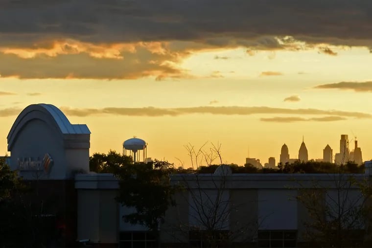 The sun sets behind the Philadelphia skyline, seen from the Shoppes at Cinnaminson on Route 130.