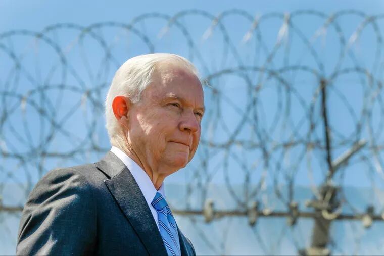 In this Friday, April 21, 2017, file photo, United States Attorney General Jeff Sessions stands near a secondary border fence during a news conference at the U.S.-Mexican border next to the Brown Field Border Patrol Station in San Diego.