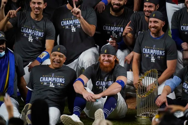 Los Angeles Dodgers manager Dave Robert and third baseman Justin Turner pose for a group picture after winning the World Series.