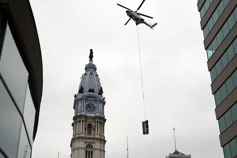 The final catwalk is removed from the top of the old Philadelphia National Bank building after removing the iconic PNB letters Sunday.