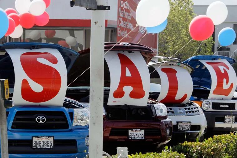 "Sale" is spelled out in the open hoods of used cars at a Toyota dealership in Glendale, Calif.