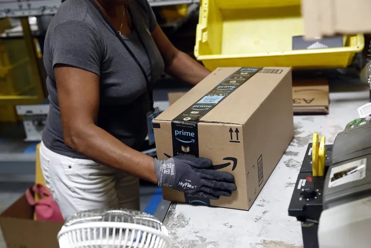 FILE- In this Aug. 3, 2017, file photo, Myrtice Harris applies tape to a package before shipment at an Amazon fulfillment center in Baltimore. Amazon's Prime Day starts July 16, 2018, and will be six hours longer than last year's and will launch new products.