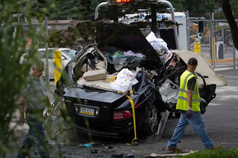 Investigators on the scene of the July 29, 2015, drag race crash that killed three people and injured another on Sandmeyer Lane in Northeast Philadelphia.