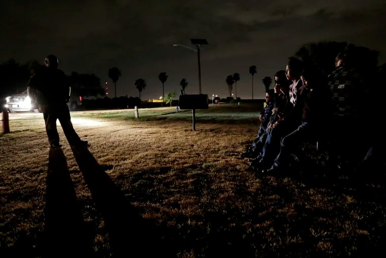 In this June 25, 2014 file photo, a group of immigrants from Honduras and El Salvador, who crossed the U.S.-Mexico border illegally, are stopped in Granjeno, Texas. During the longest-ever government shutdown, the federal judiciary has remained open, allowing the wheels of justice to keep turning in most criminal cases. In November, after a federal judge in California blocked the Trump administration from enforcing a ban on asylum for immigrants who illegally cross the southern border, government attorneys hurriedly asked a federal appeals court, then the U.S. Supreme Court, to suspend the order, terming illegal border crossings an "ongoing and increasing crisis." Both courts denied the government's request.