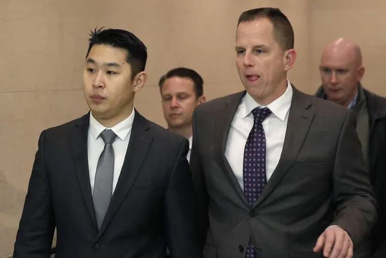 Peter Liang (left) arrives at the courthouse for his arraignment in the Nov. 20 shooting.