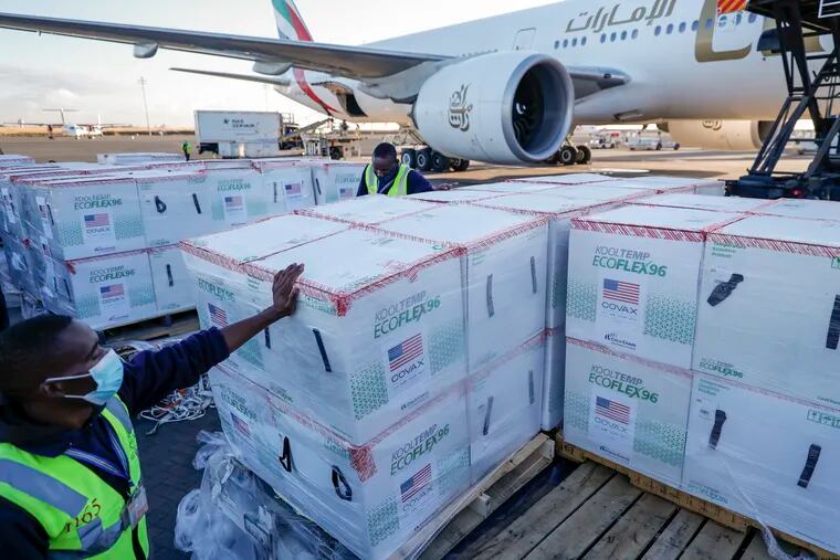 An airport worker stands next to boxes of Moderna coronavirus vaccine, donated by the U.S. government via the COVAX facility, after their arrival at the airport in Nairobi, Kenya. Moderna said Tuesday, Oct 26, 2021 that it will make up to 110 million doses of its COVID-19 vaccine available to African countries with the first 15 million doses delivered by the end of this year, 35 million in the first quarter of 2022, and up to 60 million in the second quarter of 2022.