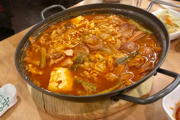 The budae jjigae "Army Stew" at Seorabol is a legacy dish from the Korean war that combines American army rations, including Spam, sausages and baked beans, into spicy Korean noodle soup.