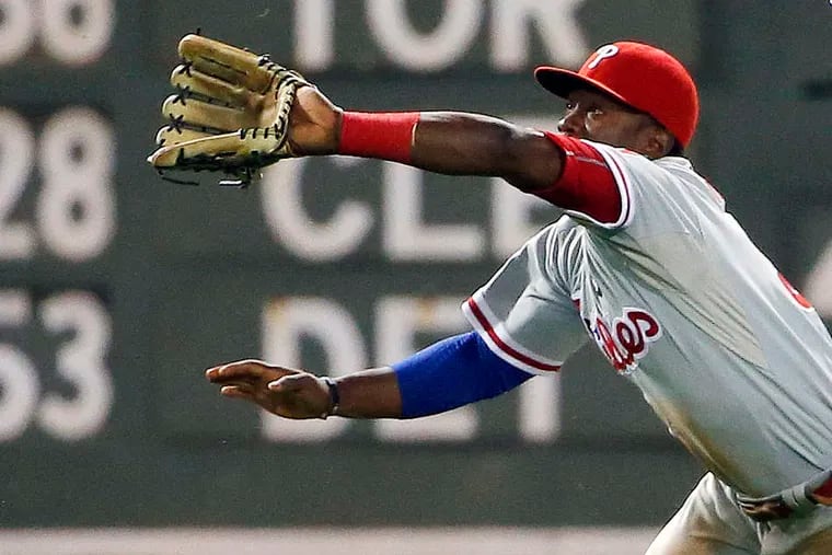 Phillies centerfider Odubel Herrera goes to his knees to make a catch of a fly ball in the third inning. WINSLOW TOWNSON / Associated Press
