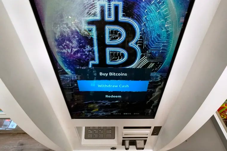 The Bitcoin logo appears on the display screen of a cryptocurrency ATM in Salem, N.H., in February.