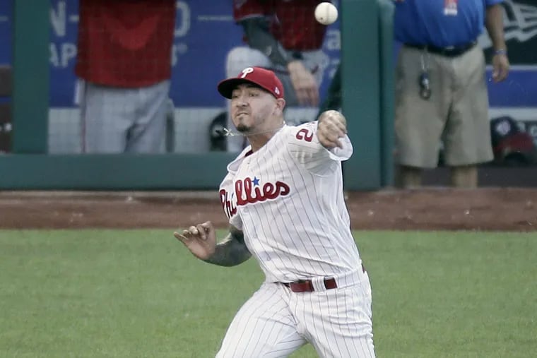 Phillies pitcher Vince Velasquez throws with his off hand after taking a hard liner to the elbow.
