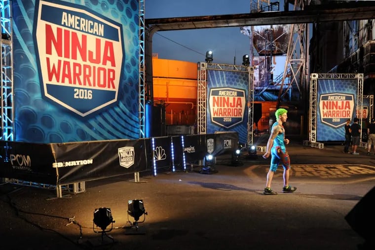 Competitor Jamie Rahn of Barrington, N.J. walks backstage while waiting to compete in the trials of NBC's American Ninja Warrior as they tape shows at the old 1925 Philadelphia Electric Company Richmond Generating Station on Delaware Avenue Thursday, May 26, 2016.