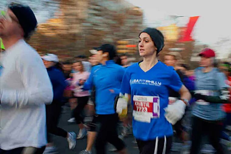 Runners panned in slow motion run down the Ben Franklin Parkway during today's marathon. (Ed Hille / Staff Photographer)