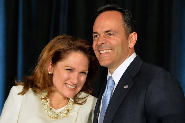 Kentucky Republican Gov.-elect Matt Bevin and his wife, Glenna, react to the cheers of supporters during his introduction at the Republican Party victory celebration Tuesday, Nov. 3, 2015, in Louisville, Ky.
