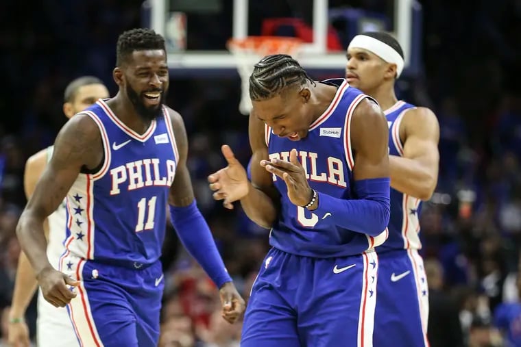 Sixers Josh Richardson (right) and James Ennis celebrate during the win against the Celtics on Oct. 23.