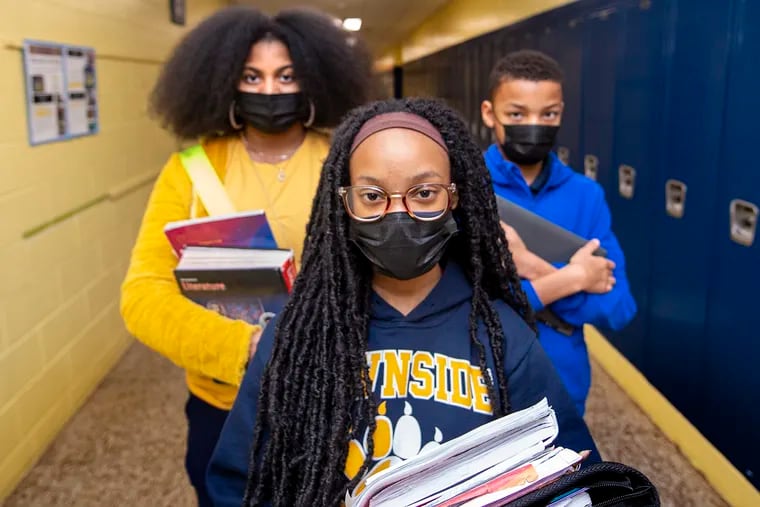 From left, Caleyse Utley and Imani Love, both 7th graders, and 5th-grader Keiden Warren pose in the hallway at Lawnside Elementary School in Lawnside, N.J.  in February.