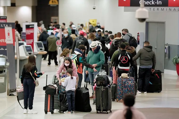 Travelers in Terminal D at Philadelphia International Airport on Dec. 19, 2021.