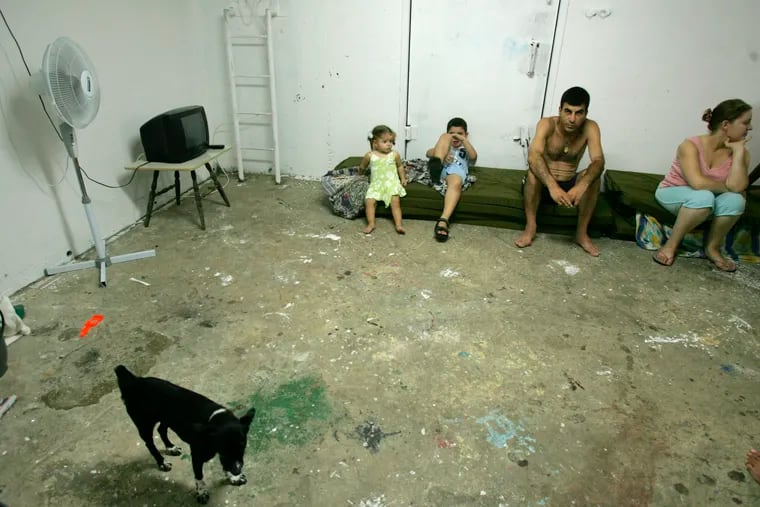 FILE - An Israeli family sits in a bomb shelter as a rocket warning siren sounds in the northern Israel town of Akko, Aug. 12, 2006. On Tuesday, Sept. 20, 2022, a U.S. court ordered the Lebanese militant group Hezbollah to pay $111 million in damages to a group of Americans who sued saying they were wounded by the group's rockets during a war with Israel in 2006. The case was brought under the U.S. Anti-Terrorism Act and alleged that Hezbollah caused the plaintiffs physical and emotional injury and damaged their property.