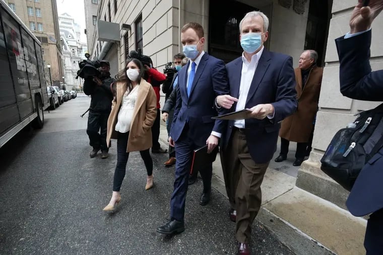 Brandon Bostian, center, the engineer of the 2015 Amtrak crash, leaves the Criminal Justice Center on Feb. 24, 2022 after the first day of his criminal trial.