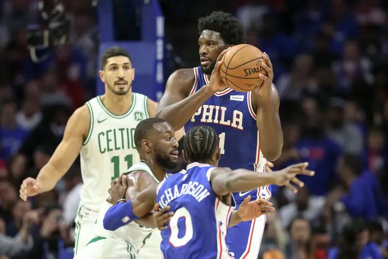 Sixers' Joel Embiid looks to pass against the Celtics during the 1st quarter of the season home opener at the Wells Fargo Center in Philadelphia, Wednesday, October  23, 2019.