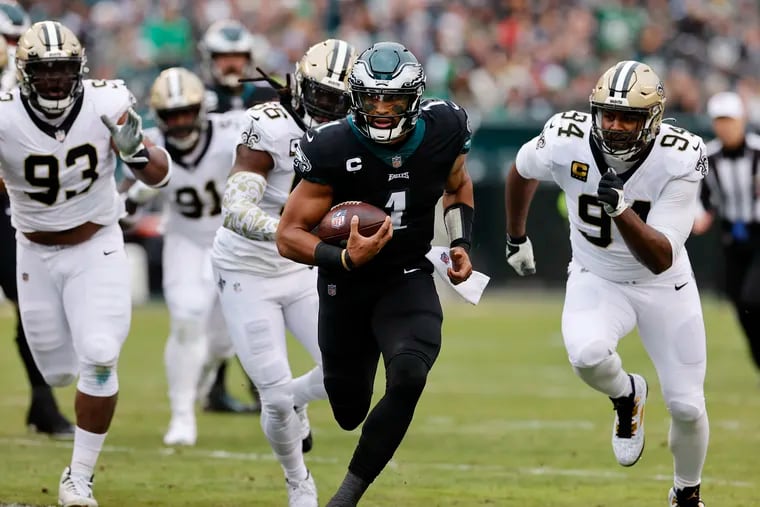 Philadelphia Eagles quarterback Jalen Hurts (1) is chased by the New Orleans Saints defense during the first quarter Sunday, November 21, 2021 at Lincoln Financial Field in Philadelphia, Pa.