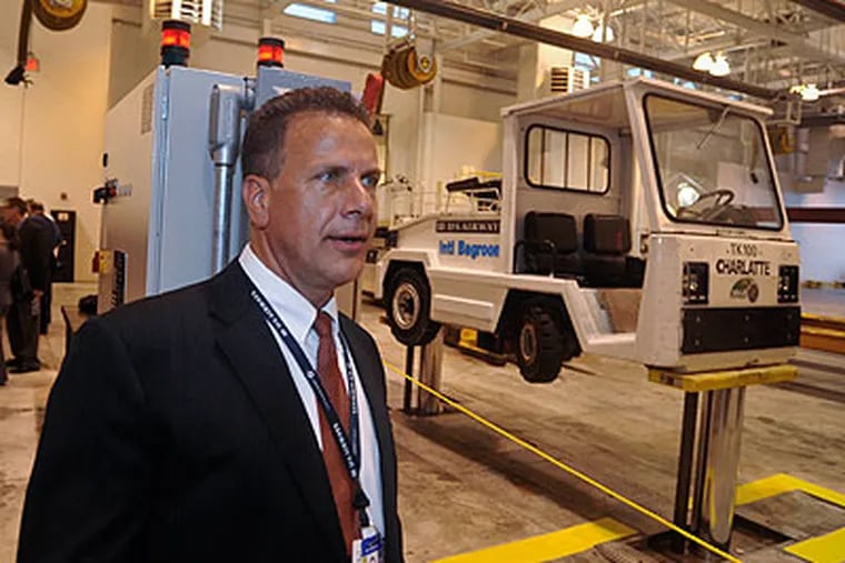 Jim Brewer, Manager of U.S. Air's Ground Service, stands in the new ground equipment repair facility which had its grand opening Friday. (Ron Tarver / Staff Photographer)