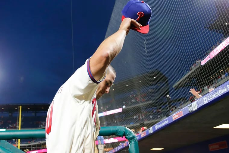 Phillies catcher J.T. Realmuto tips his cap to fans after the Phillies beat the Atlanta Braves 8-6 on Saturday, March 30, 2019 in Philadelphia.