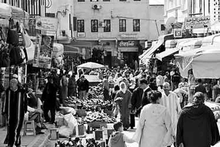 Crowds pack the markets in the old town of Meknes. Nearby vineyards produce most of the wine bottled in Morocco.