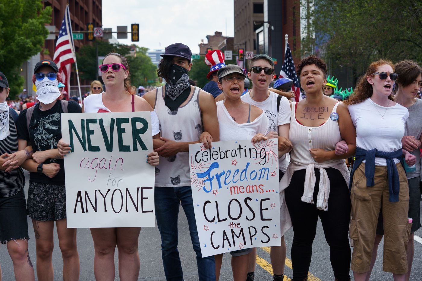 Protesters interrupt the Salute to America parade with a message demanding the closure of detention camps at the United States-Mexico border.