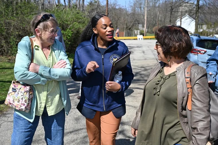 U.S. Rep. Summer Lee, center, walks with Katie Forsythe, left, and Lisa Messineo, right, after a check presentation for funds to repair the Fourth Street Bridge in North Irwin, Pa. Forsythe and Messineo are with the Norwin Penn Trafford Area Democrats.