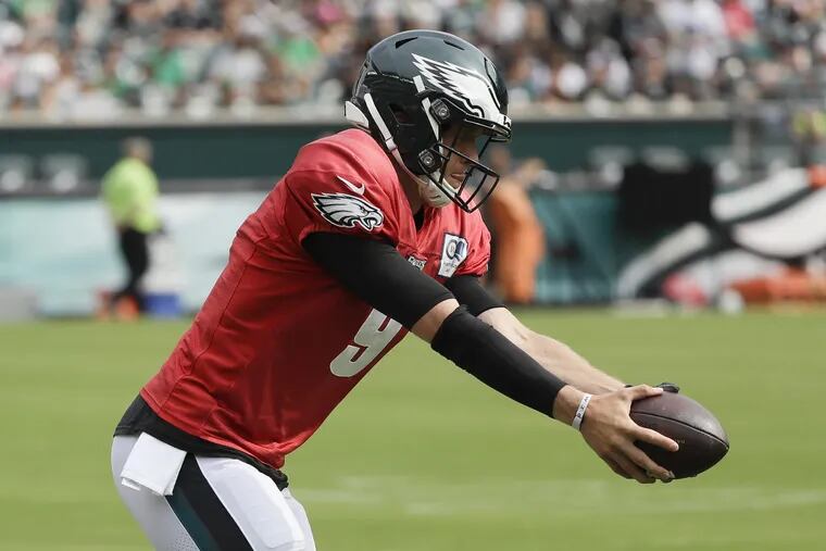 Nick Foles makes a handoff during Saturday's practice, the first he participated in after missing three straight due to neck spasms.