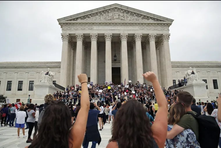 Activists protest on the steps and plaza of the Supreme Court after the confirmation vote of Supreme Court nominee Brett Kavanaugh, on Saturday.