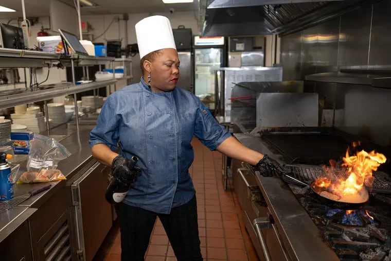 Chef Tanesha Trippett tends to a skillet in the kitchen of Jacobs Restaurant in Philadelphia's West Oak Lane section.