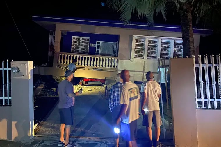 A collapsed building with car crushed underneath, following an earthquake in Yauco, Puerto Rico, on Tuesday.  All the occupants of the home are reported to be uninjured.