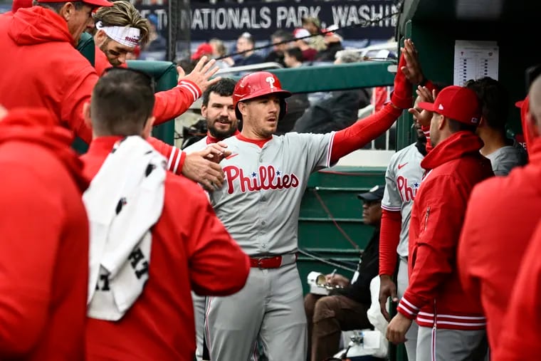 Phillies catcher J.T. Realmuto, center, celebrates after he scored on a triple by teammate Alec Bohm during the second inning of a 5-2 win over the Washington Nationals on Saturday.